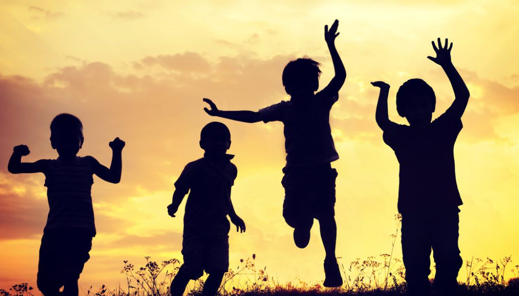 silhouette of children playing in sunset